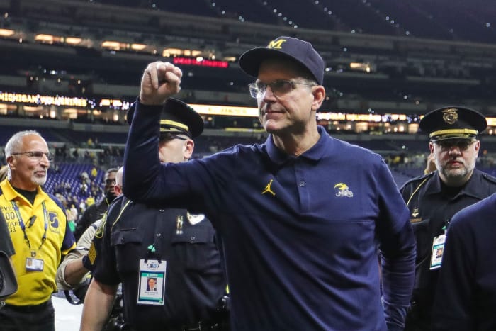 Jim Harbaugh pumps his fist after Michigan’s Big Ten championship win.